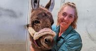 Dr. Andee Frei poses for a portrait with a cute little burro.