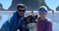 Two people and a dog on a beach at the Oregon Coast