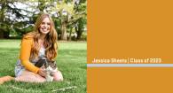 Jessica Sheets poses with a cat on a lawn.
