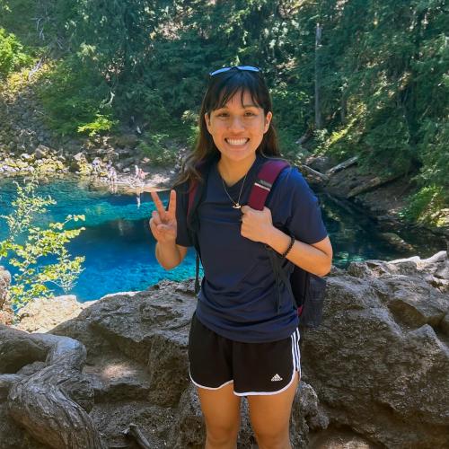 Jaycie Ota outside in front of a creek.