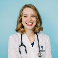 Ann Ramsey portrait in white coat and stethoscope.