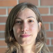 Sara Minerva portrait with brick background. 
