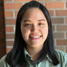 Portrait of Dr. Guan with brick background